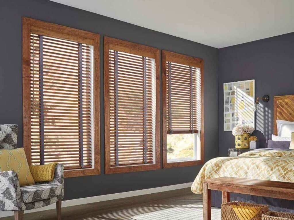 Graber wood blinds with natural grain finish providing warm style and adjustable light control in cozy bedroom